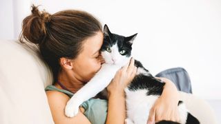 Woman snuggling cat