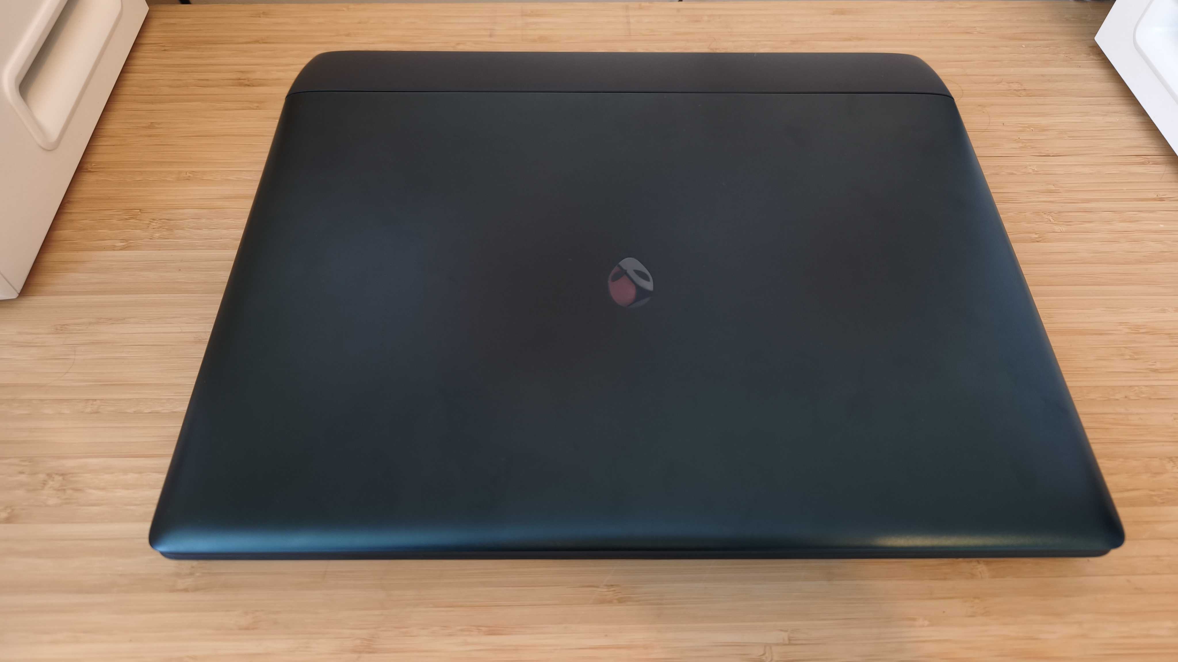 An Alienware 16 Area-51 laptop on a wooden desk