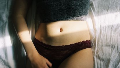 Midsection Of Young Woman Sleeping In Bed - masturbation gap - stock photo