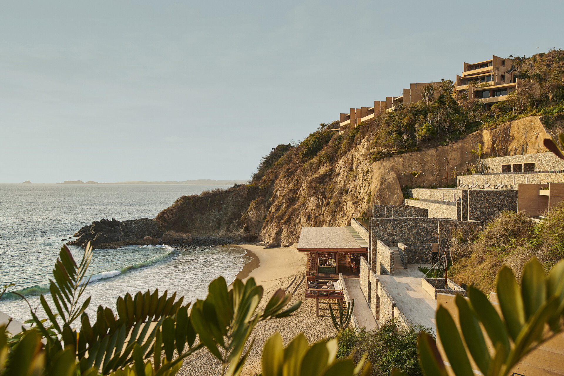 the four seasons tamarindo hotel on the shore of the pacific ocean at golden hour
