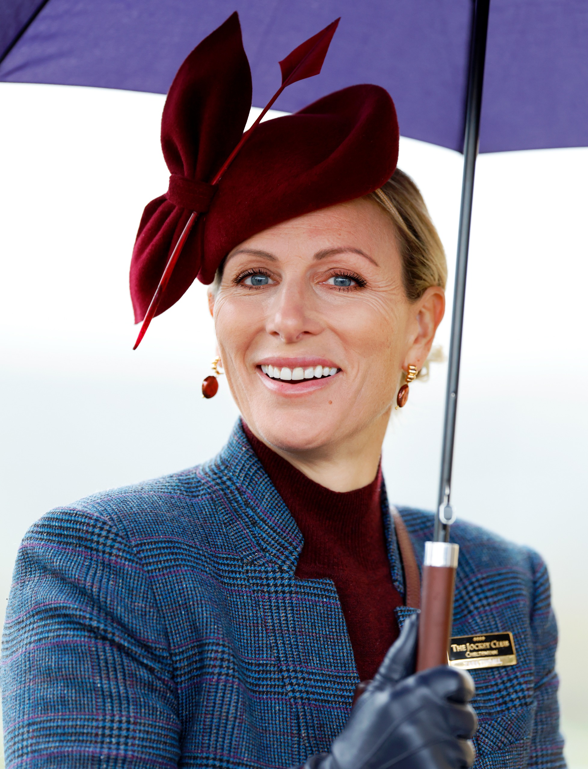 Zara Tindall shelters under an umbrella as she attends day 2 of The William Hill Showcase horse racing meeting at Cheltenham Racecourse on October 24, 2026. (Photo by Max Mumby/Indigo/Getty Images)