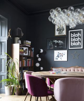 Dramatic living-dining area with black walls and ceiling