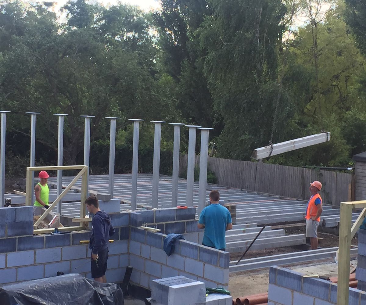 Progress shots of a self build home men putting up block construction