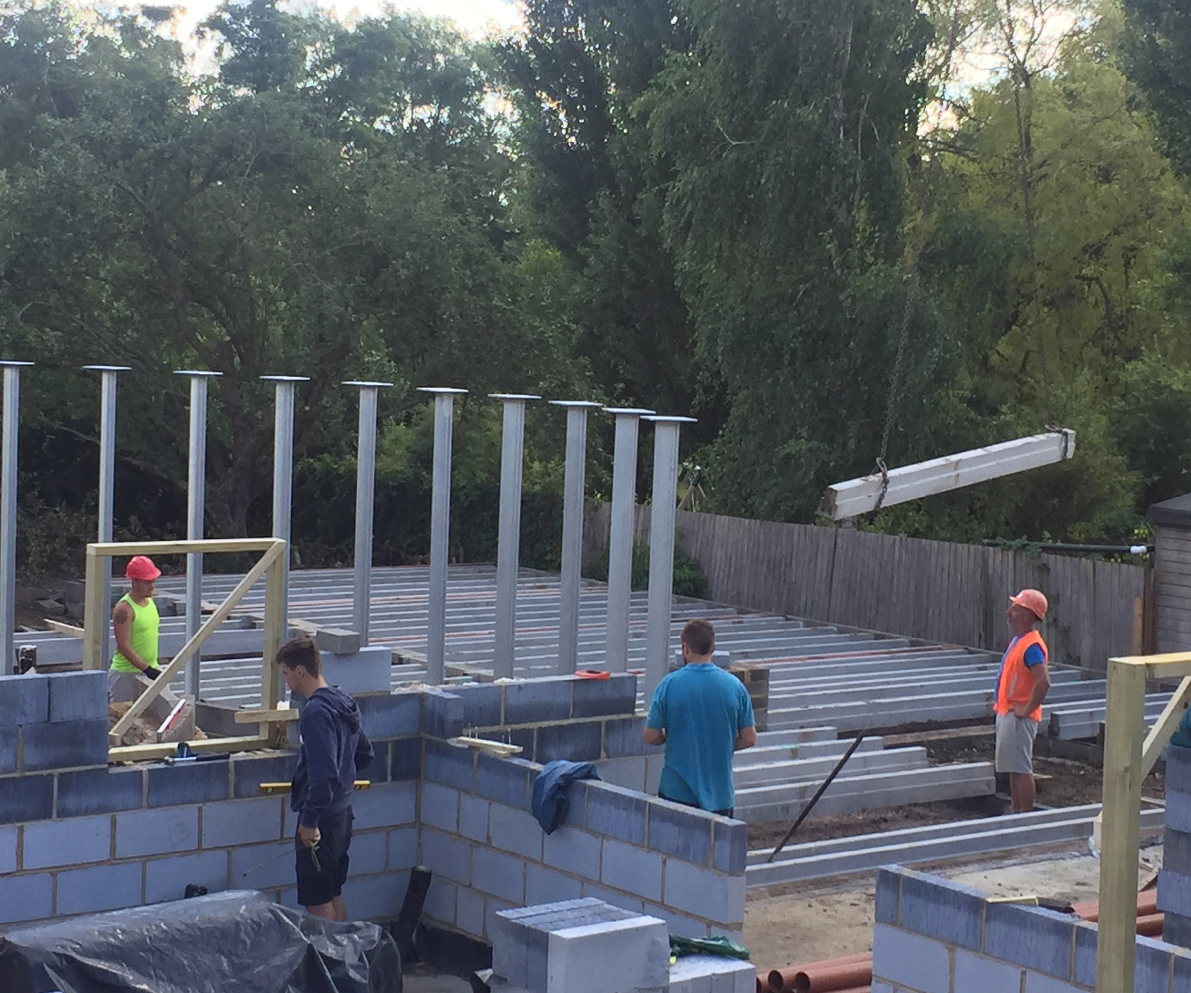 Progress shots of a self build home men putting up block construction