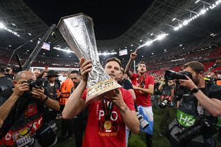 Ivan Rakitic of Sevilla FC hands the UEFA Europa League trophy to the Sevilla FC fans after the team's victory in the penalty shoot out during the UEFA Europa League 2022/23 final match between Sevilla FC and AS Roma at Puskas Arena on May 31, 2023 in Budapest, Hungary. (Photo by Justin Setterfield/Getty Images)