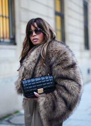 French street style - woman wearing a fur coat