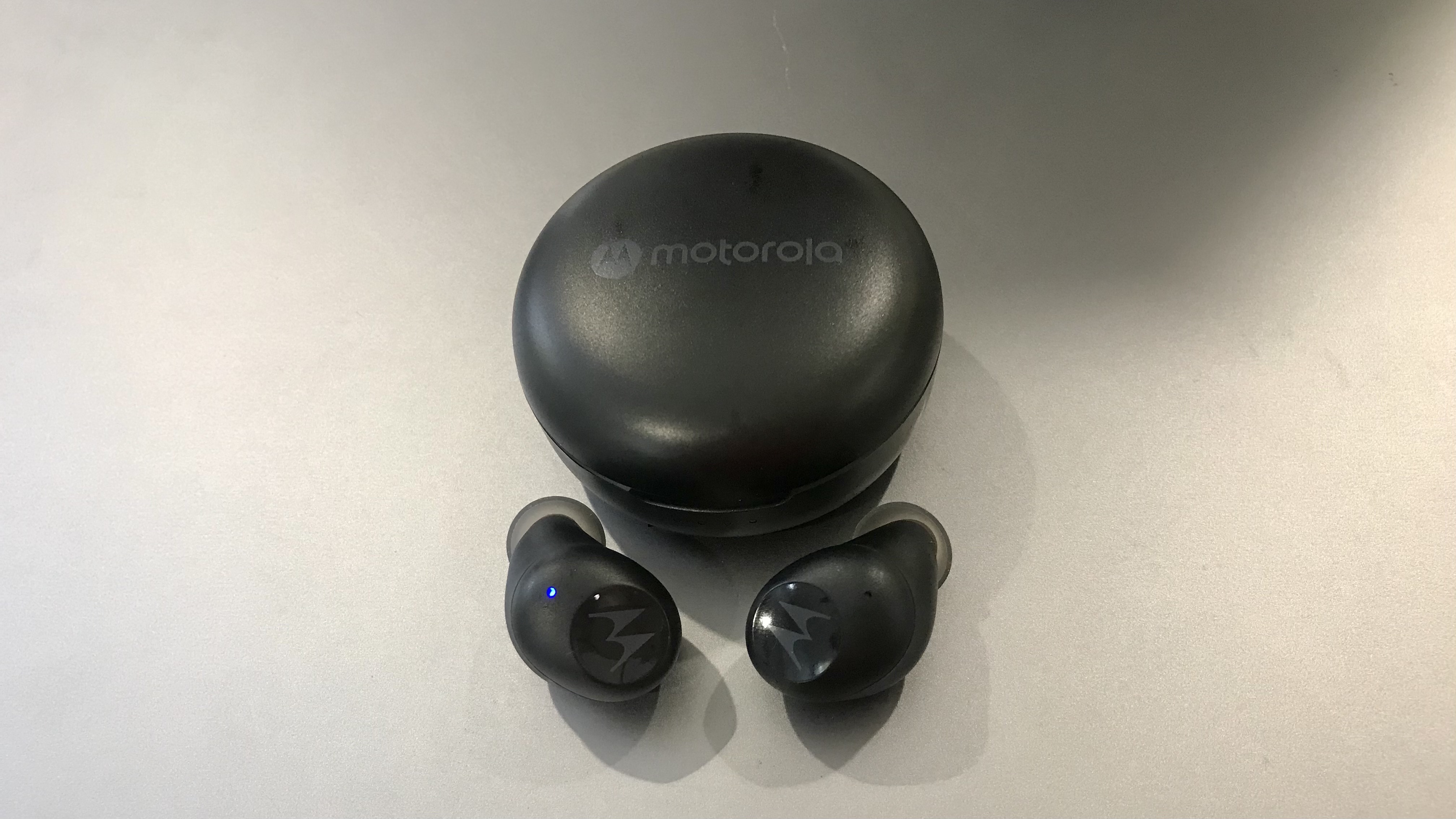 Moto Buds 150 and case, on silver background
