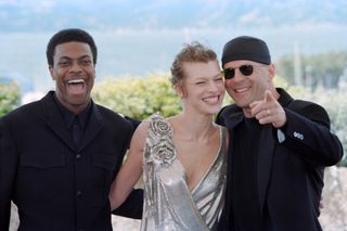 Chris Tucker, Ukrainian actress Milla Jovovich and US actor Bruce Willis pose for the presentation of the film "The Fifth Element" directed by Luc Besson during the 50th Cannes Film Festival in Cannes, southern France, on May 7, 1997.