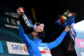LIDODIFERMO ITALY MARCH 15 Podium Tadej Pogacar of Slovenia and UAE Team Emirates Blue Leader Jersey Celebration during the 56th TirrenoAdriatico 2021 Stage 6 a 169km stage from Castelraimondo to Lido di Fermo Mask Covid safety measures Flowers TirrenoAdriatico on March 15 2021 in Lido di Fermo Italy Photo by Tim de WaeleGetty Images