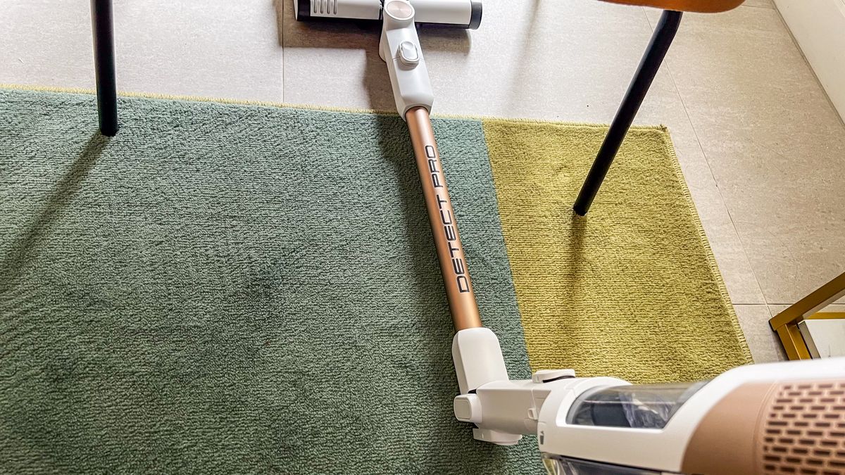 The Shark Cordless Detect Pro tube bent under a chair