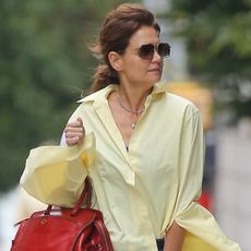 Katie Holmes was spotted in New York wearing a cherry red top handle bag and matching ballet flats
