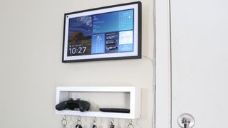 An Echo Show 15 in landscape mode mounted to the wall