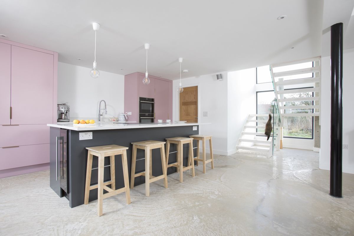 pink kitchen and staircase in self build home
