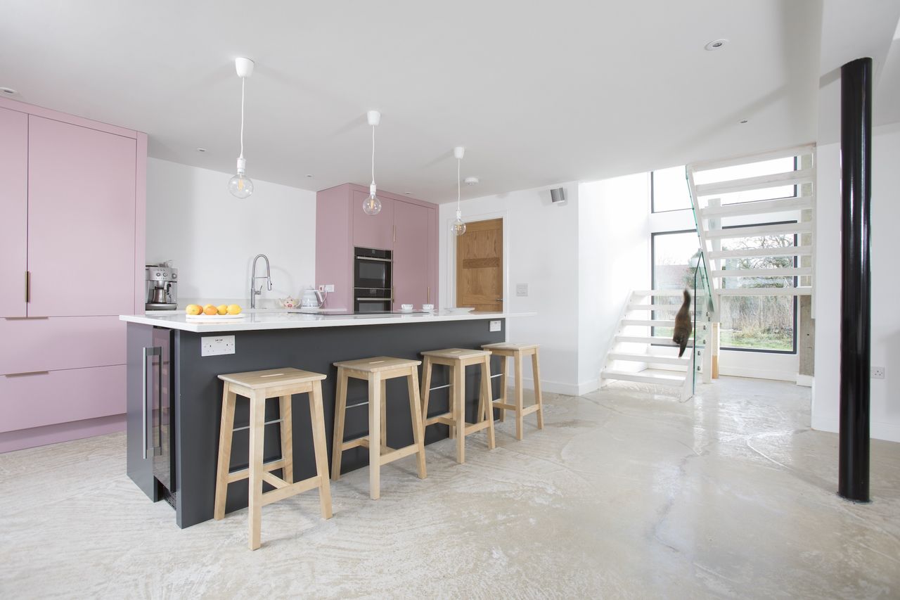pink kitchen and staircase in self build home