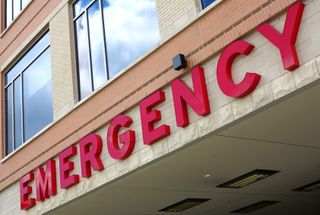 Emergency room sign on hospital building.