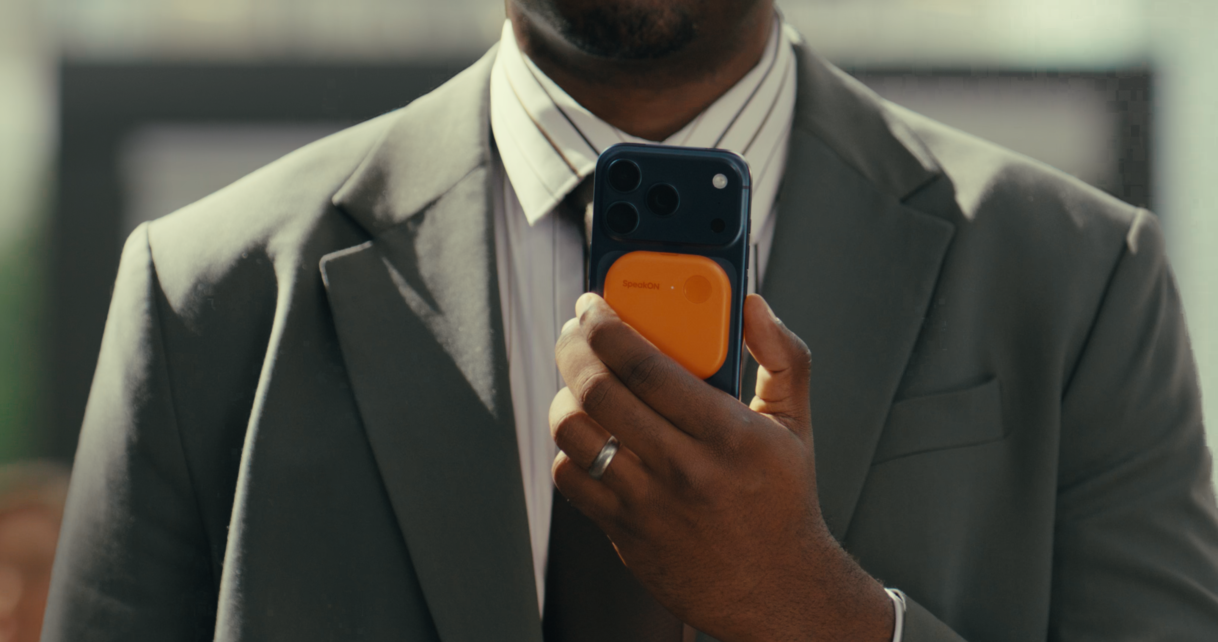 SpeakON MagSafe AI button in use by business professions using iPhones.