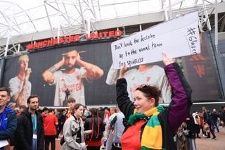 Manchester United fans protest against the Glazers with a sign referencing articles that have recently come out about the Mason Greenwood situation during the Premier League match between Manchester United and Wolverhampton Wanderers at Old Trafford on August 14, 2023 in Manchester, England.