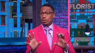 Nick Cannon in pink suit hosting talk show