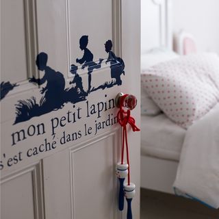 bedroom with stencil design on white door