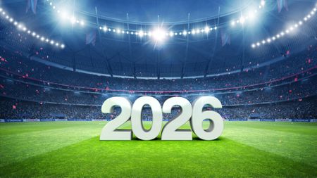 A soccer stadium with the text "2026" displayed on the field. 