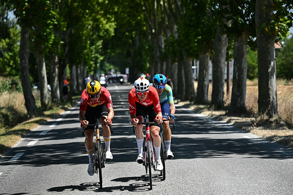 Team Jayco AlUla team's Swiss rider Mauro Schmid (C), Uno-X Mobility team's Norwegian rider Jonas Abrahamsen (L) and XDS Astana Team's Italian rider Davide Ballerini (R) cycle in a breakaway during the 11th stage of the 112th edition of the Tour de France cycling race, 156.8 km starting and finishing in Toulouse, southwestern France, on July 16, 2025. (Photo by Loic VENANCE / AFP)