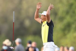 Haotong Li celebrates holing the winning putt at the 2025 Qatar Masters