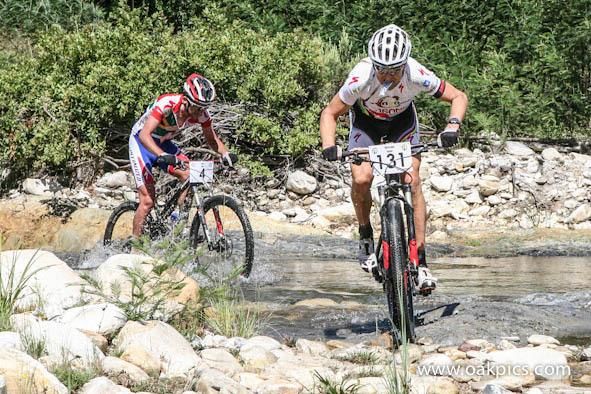 Christoph Sauser lead Max Knox through a river crossing.