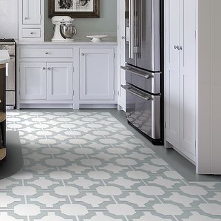 Neisha Crosland Parquet Vinyl Floor Tiles in stone colour, in a kitchen with white cabinets and silver fridge freezer