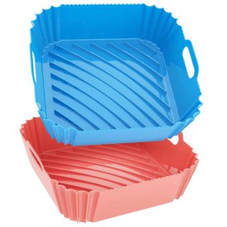 Two square ridged red and blue air fryer liners with integrated handles