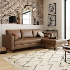 Dunelm sofa with carpet against a brick wall