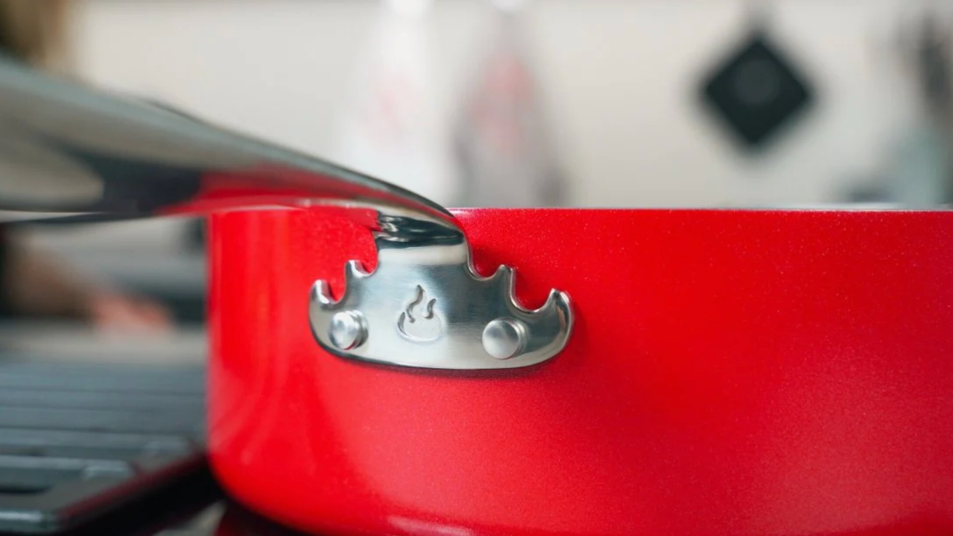 The flame on the side of the Guy Fieri's ceramic cookware pan