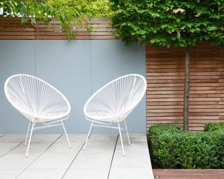 Slim white chairs illustrate how to plan a small garden