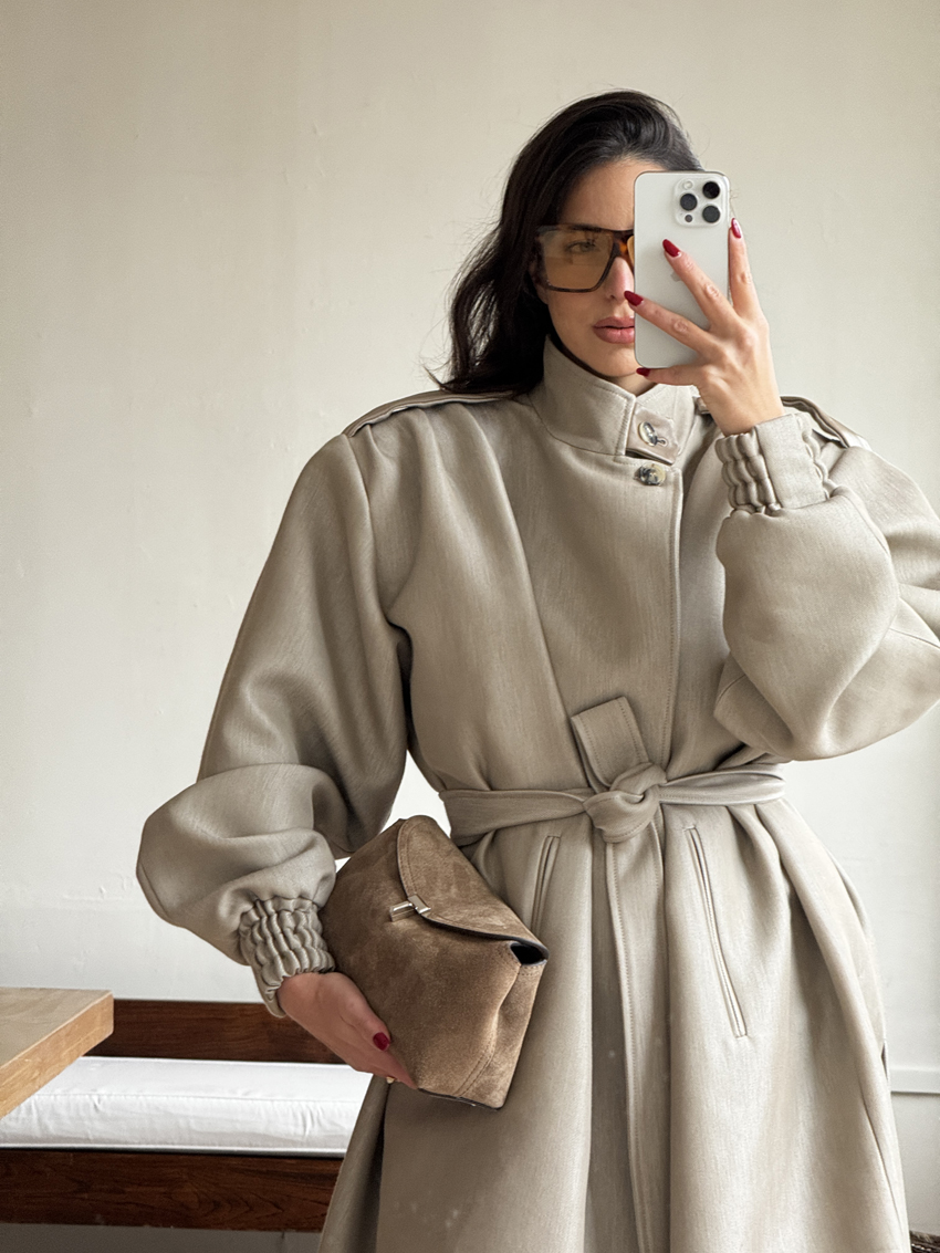 Bettina Looney carrying a Toteme suede T-Lock Clutch.