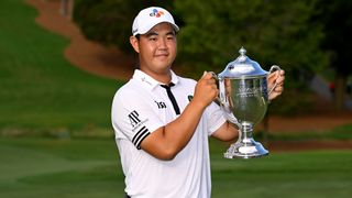 Tom Kim with the trophy after winning the 2022 Wyndham Championship at Sedgefield