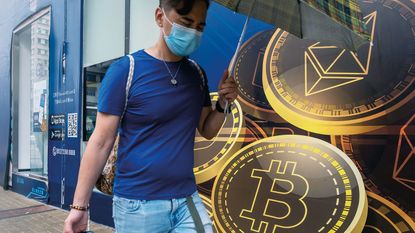 A pedestrian walking past a Hong Kong cryptocurrency exchange
