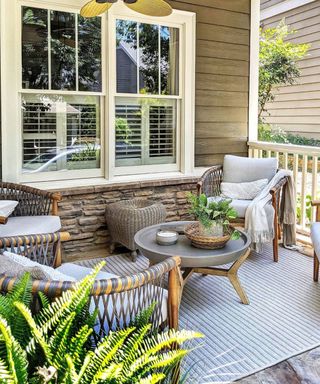 Front porch ideas by Julia Reynolds with rattan chairs and outdoor rug.
