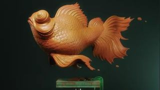 Image of plastic goldfish on a green pedestal