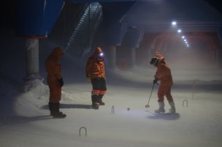 Staff wintering over at the British Antarctic Survey's Halley station play a round of outdoor croquet in 40 mph winds and freezing temperatures to celebrate the Queen's Diamond Jubilee.
