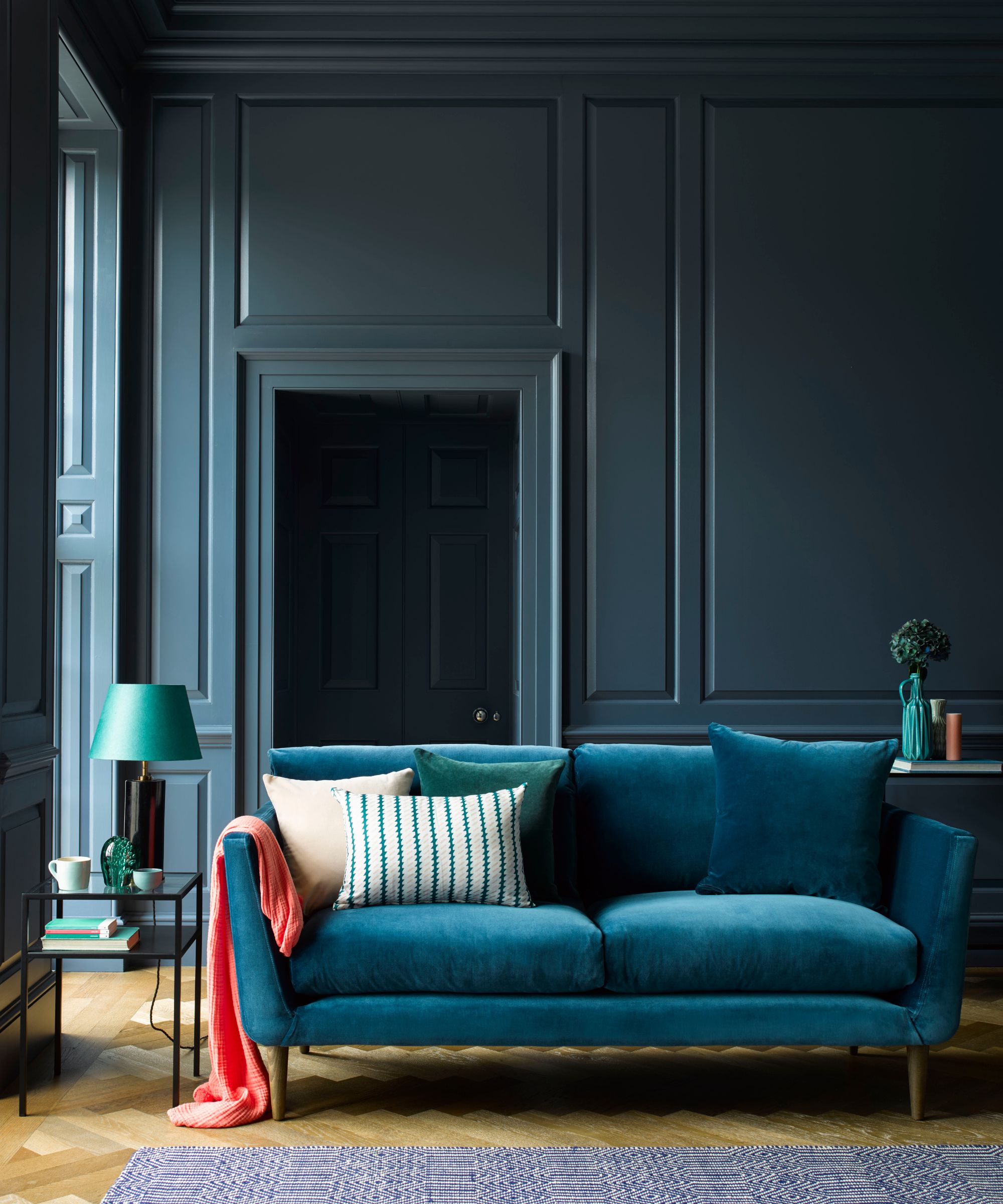 Living room with dark blue walls and matching sofa