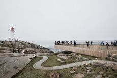 Image of a lighthouse on a dull day next to the sea