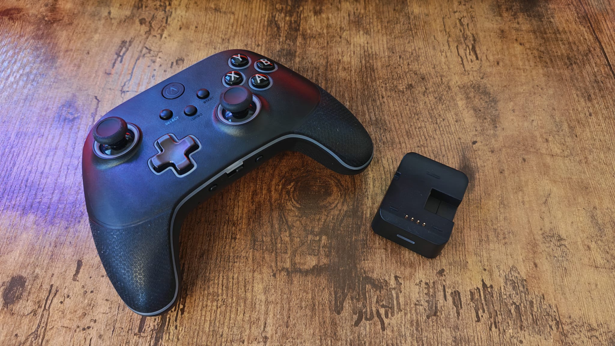 The PowerA OPS V3 next to its charging stand