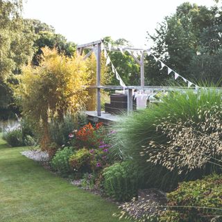 A garden with blooming plants and a bunting