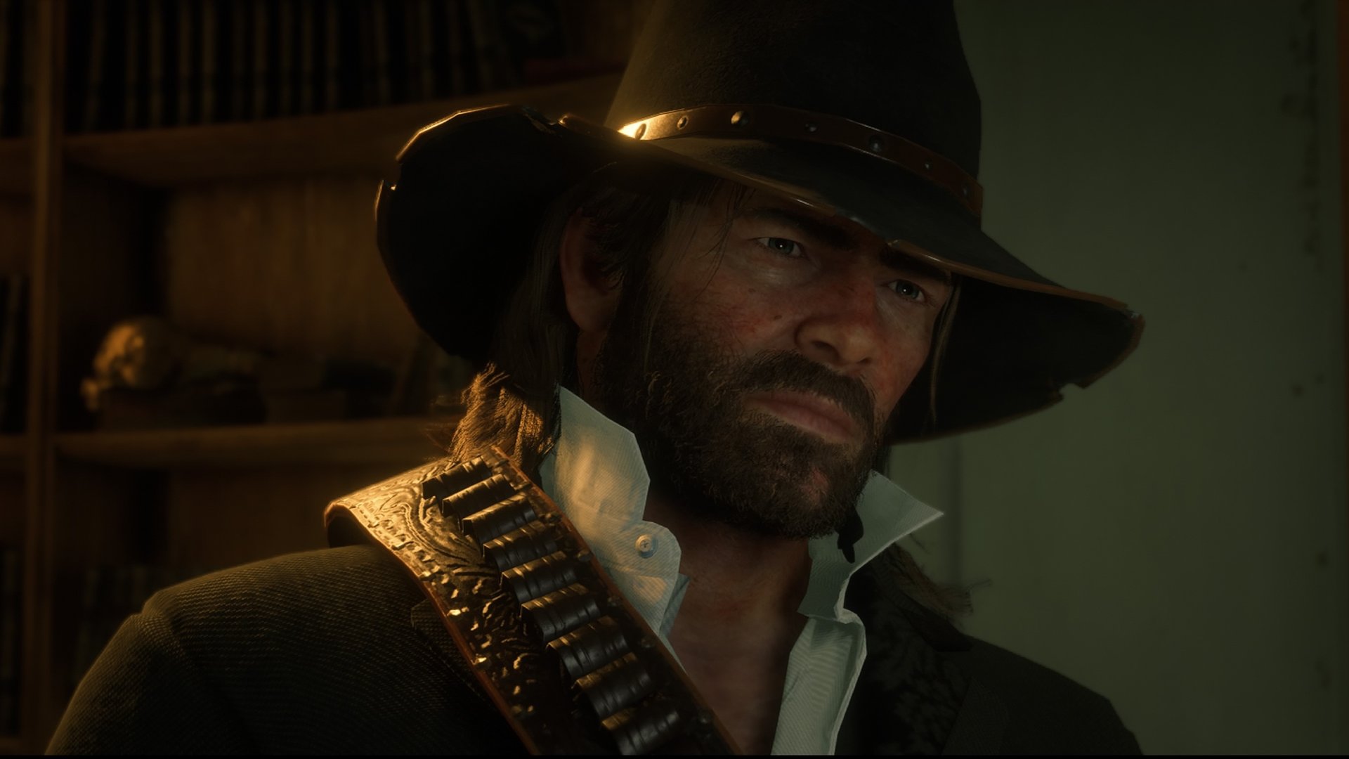 Red Dead Redemption 2 screenshot of Arthur Morgan who has shoulder length hair and a beard and wears a cowboy hat