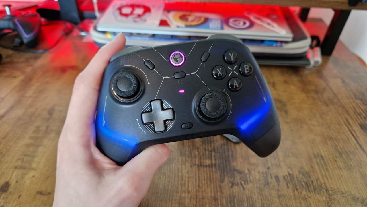 The GameSir Cyclone 2 being held by a reviewer