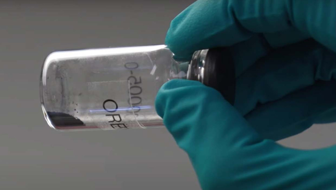 Ash dust and small rocks in a glass vial