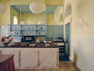 Yellow-accented interior of Café Petiole, London