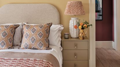 Pale yellow bedroom with textured lampshade, throw and pillows