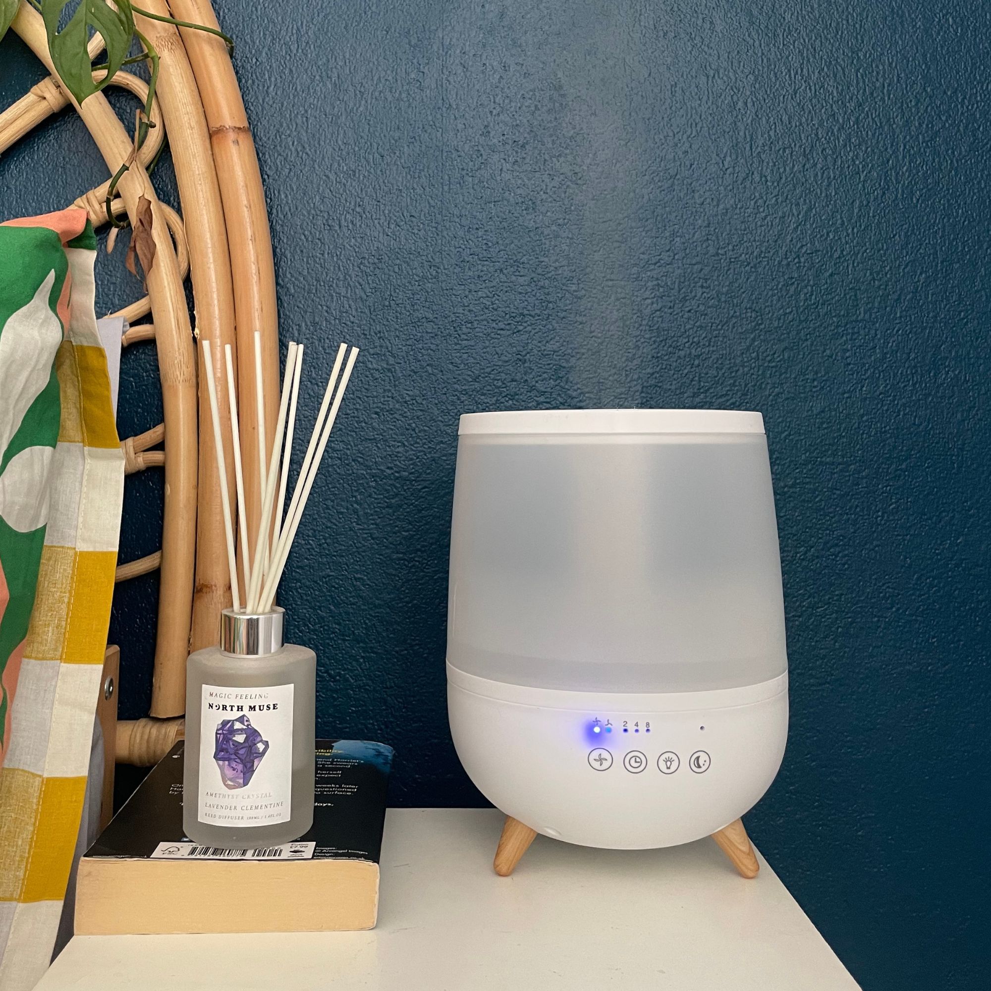 Dunelm humidifier on a bedside table next to a reed diffuser