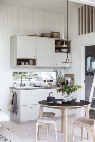 A small white cabin kitchen decorated in a Scandi-style