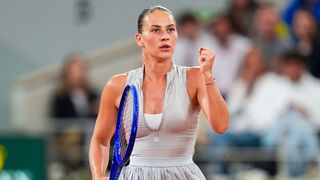 Marta Kostyuk clenches her fist after winning a point at the French Open 2026